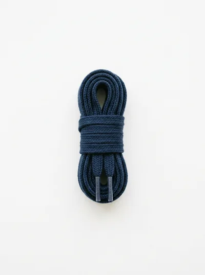 Coiled Navy Blue Shoelaces On White Background