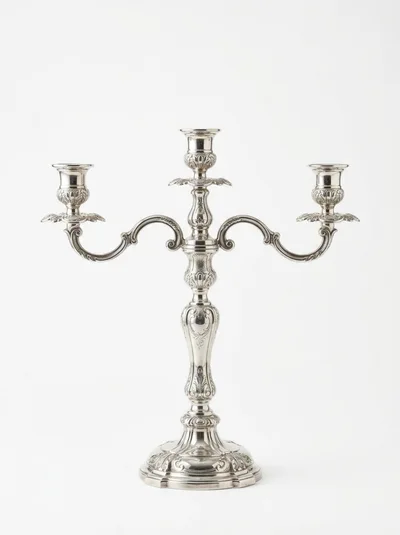 Ornate Silver Candelabra Against A Plain White Background