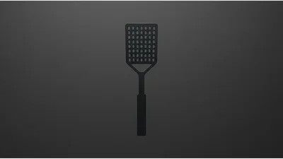 Black Slotted Spatula Isolated On Dark Background