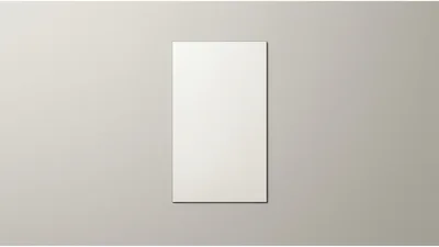 Blank Vertical Paper Sheet On A Neutral Wall