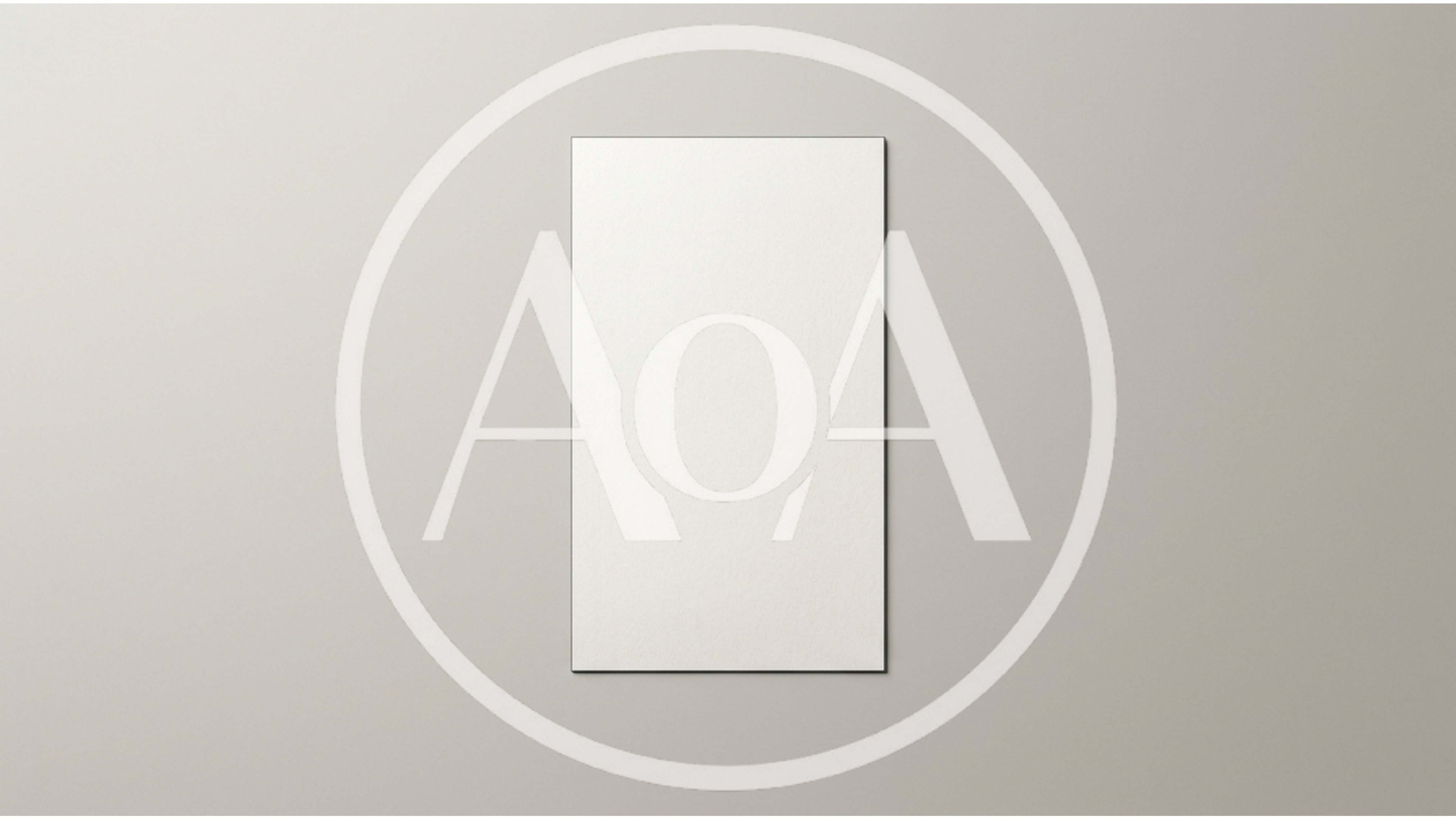 Blank Vertical Paper Sheet On A Neutral Wall