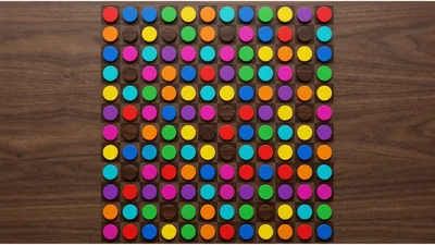 Colorful Circular Game Pieces Arranged On Wooden Board