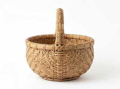 Woven Rattan Basket With Handle On White Background