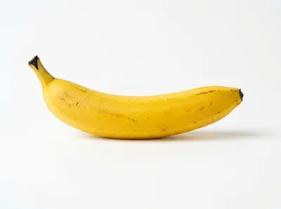 Single Ripe Yellow Banana on White Background