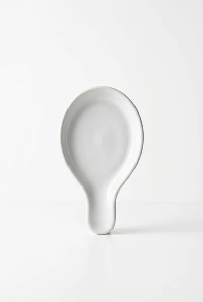 White Ceramic Spoon Rest On White Background