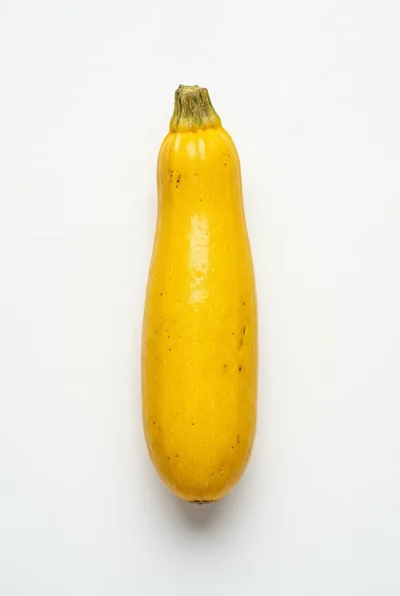 Single Fresh Yellow Summer Squash on White Background