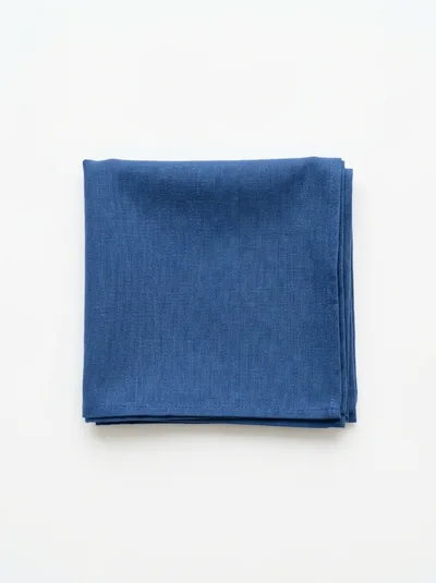 Folded Blue Linen Napkin on White Background