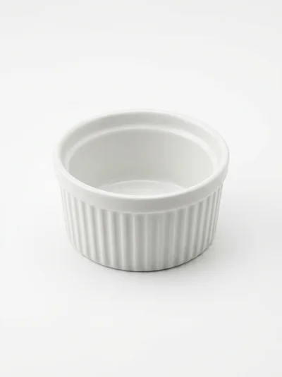 Empty White Ceramic Ramekin On A Plain Background