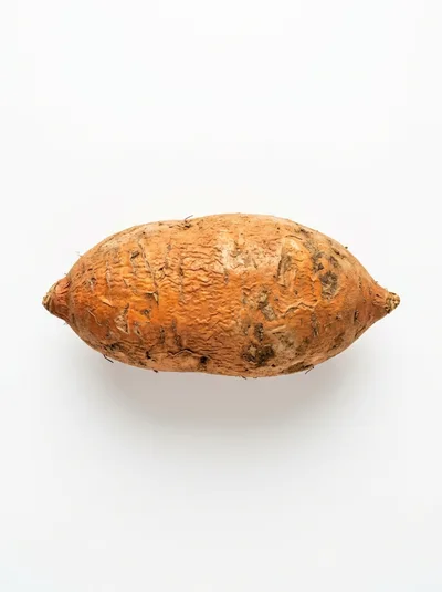 Single Raw Sweet Potato On White Background