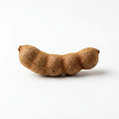 Single Whole Tamarind Pod on White Background