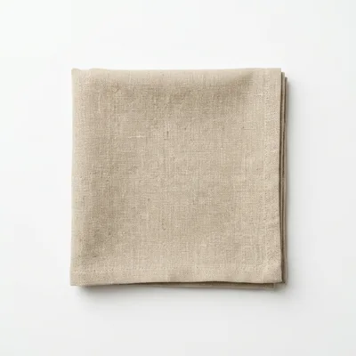 Folded Beige Linen Napkin on White Background