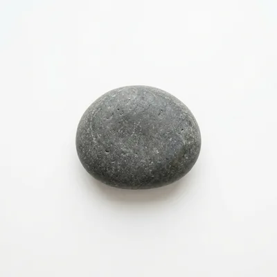 Single Smooth Grey River Stone On White Background