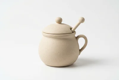 Ceramic Honey Pot With Dipper On White Background