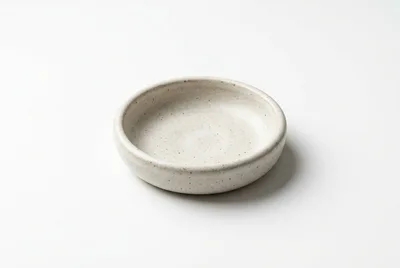 Minimalist Speckled Ceramic Bowl On White Background
