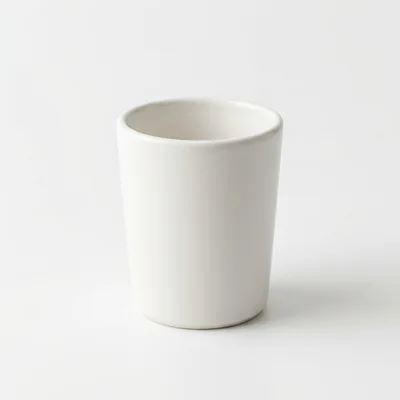 Minimalist White Ceramic Cup On White Background