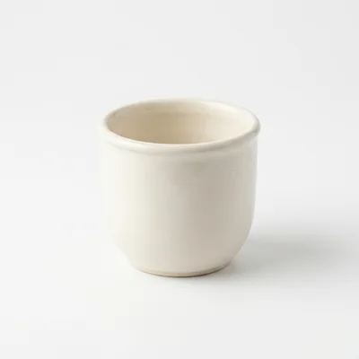 Minimalist Off-White Ceramic Cup On White Background