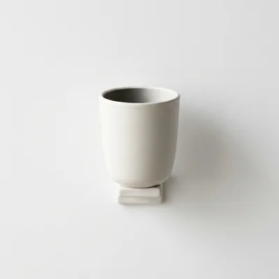 Minimalist Ceramic Cup Mounted On A White Wall