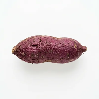 Single Raw Purple Sweet Potato Isolated On White