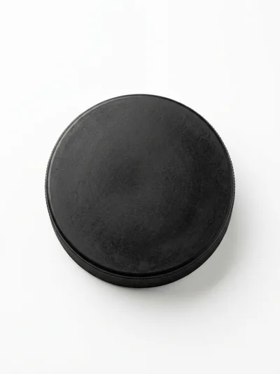 Single Black Ice Hockey Puck On White Background