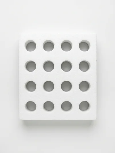 White Styrofoam Block With Sixteen Circular Holes