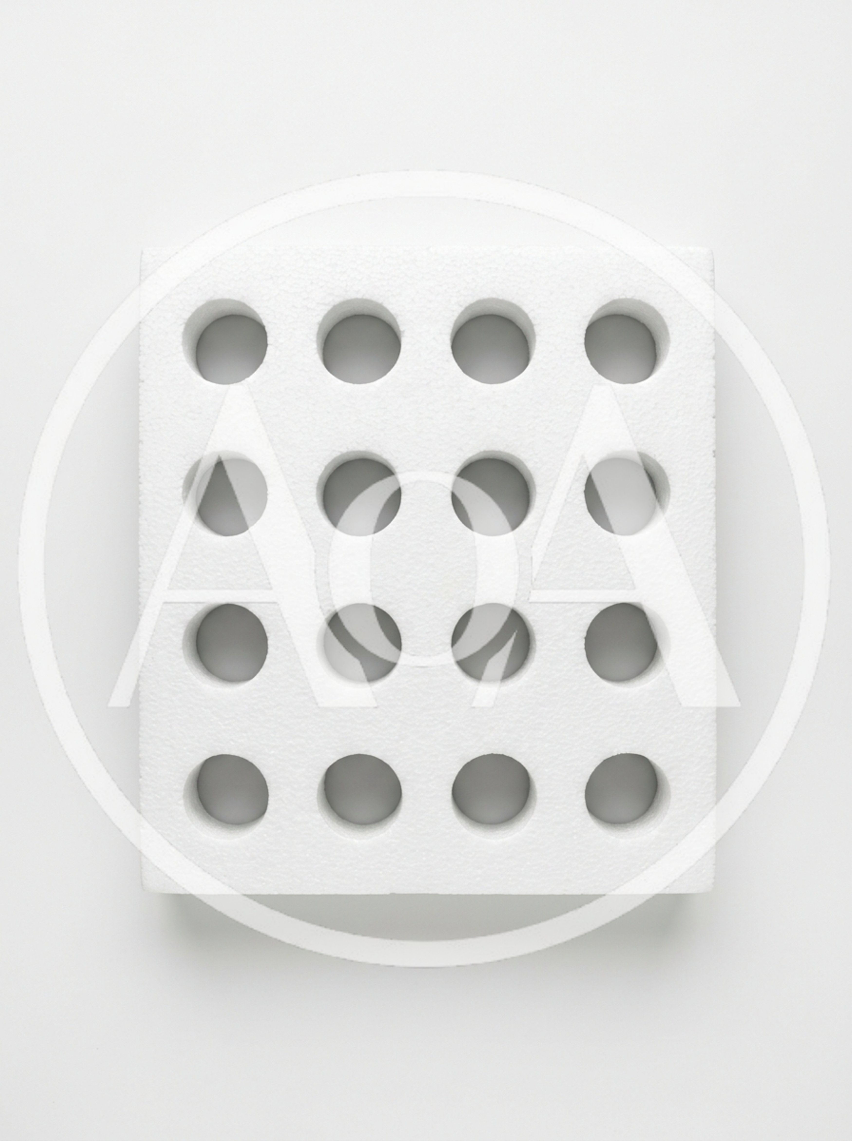 White Styrofoam Block With Sixteen Circular Holes