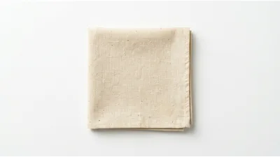 Folded Beige Linen Napkin on White Background