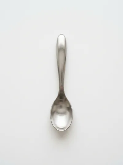 Single Stainless Steel Spoon On White Background