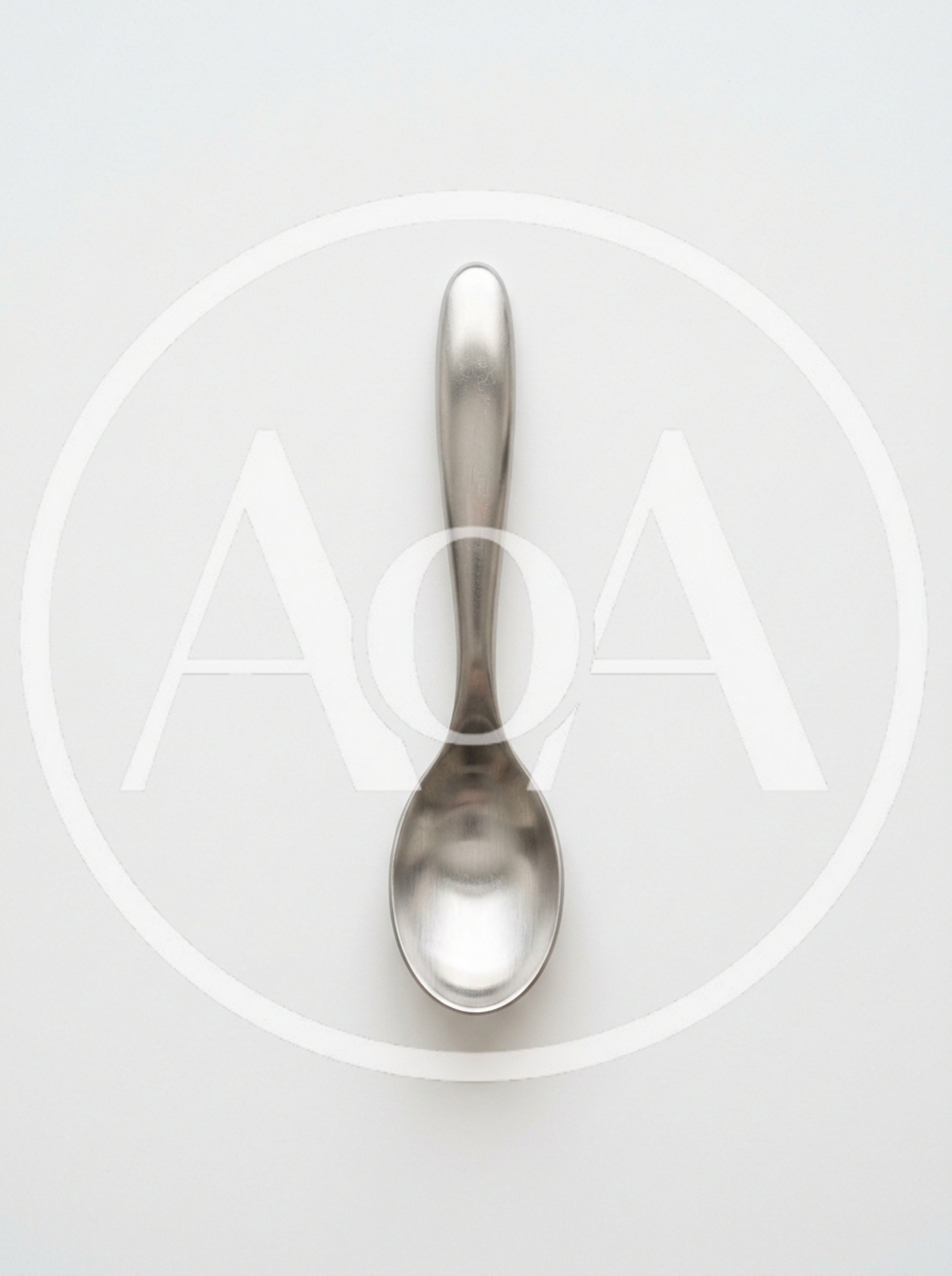 Single Stainless Steel Spoon On White Background