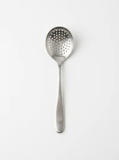 Stainless Steel Slotted Spoon On White Background