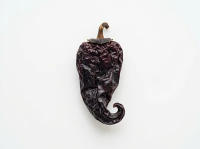 Single Dried Ancho Chili Pepper on White Background