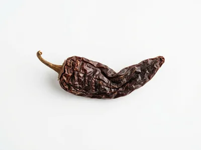 Single Dried Chipotle Chili Pepper on White Background
