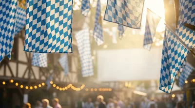 Bavarian Flags Hanging At An Outdoor Oktoberfest Celebration