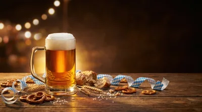 Oktoberfest Beer Mug With Pretzels On Wooden Table