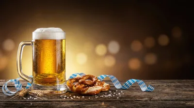 Oktoberfest Beer Mug With Pretzel On Wooden Table