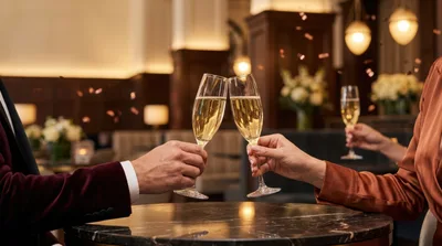 Couple Toasting With Champagne Flutes In Elegant Restaurant