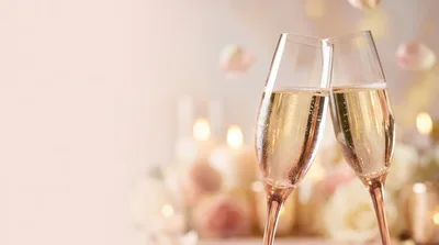Two Champagne Flutes Toasting At A Wedding Celebration
