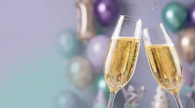 Two Champagne Flutes Toasting At A Celebration