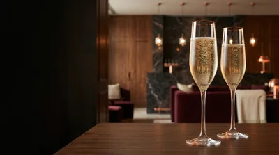 Two Champagne Flutes On A Wooden Table