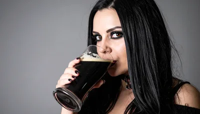 Gothic Woman Drinking Dark Beer From A Glass