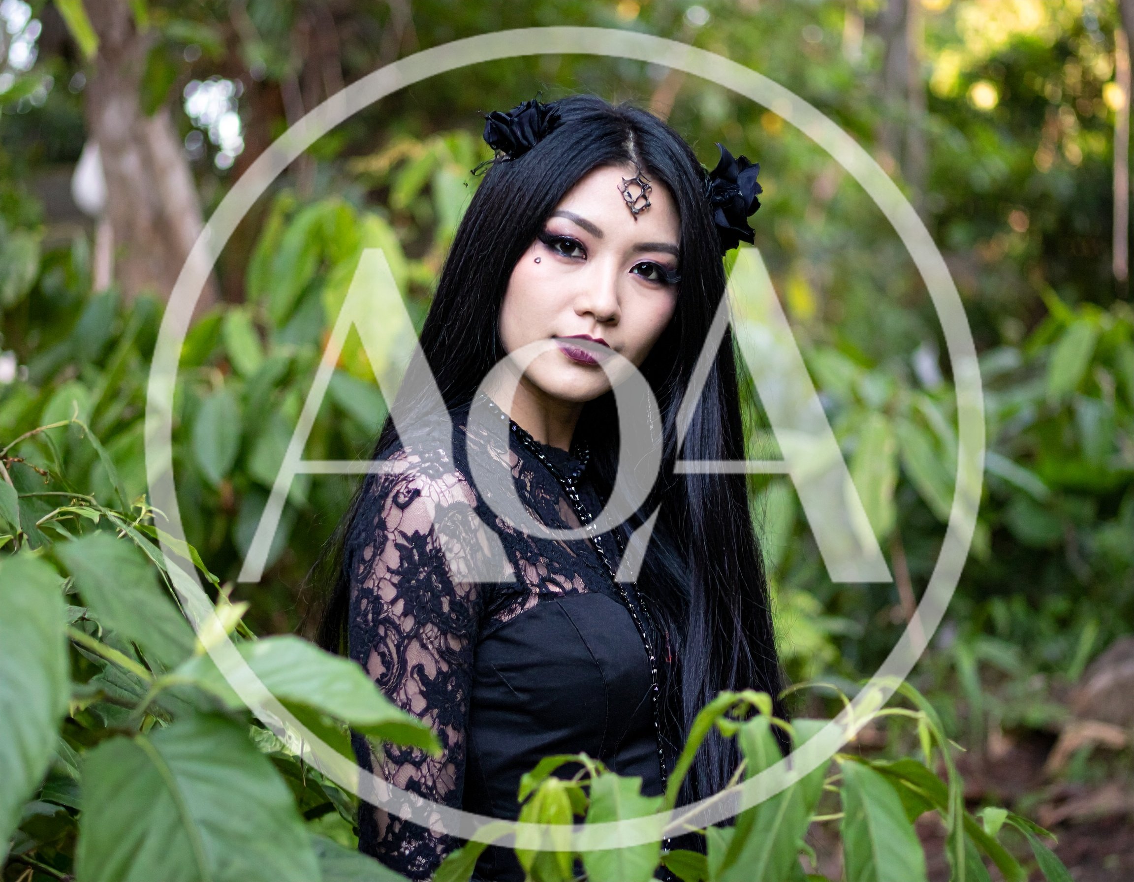 Gothic Woman With Black Hair In Lush Forest