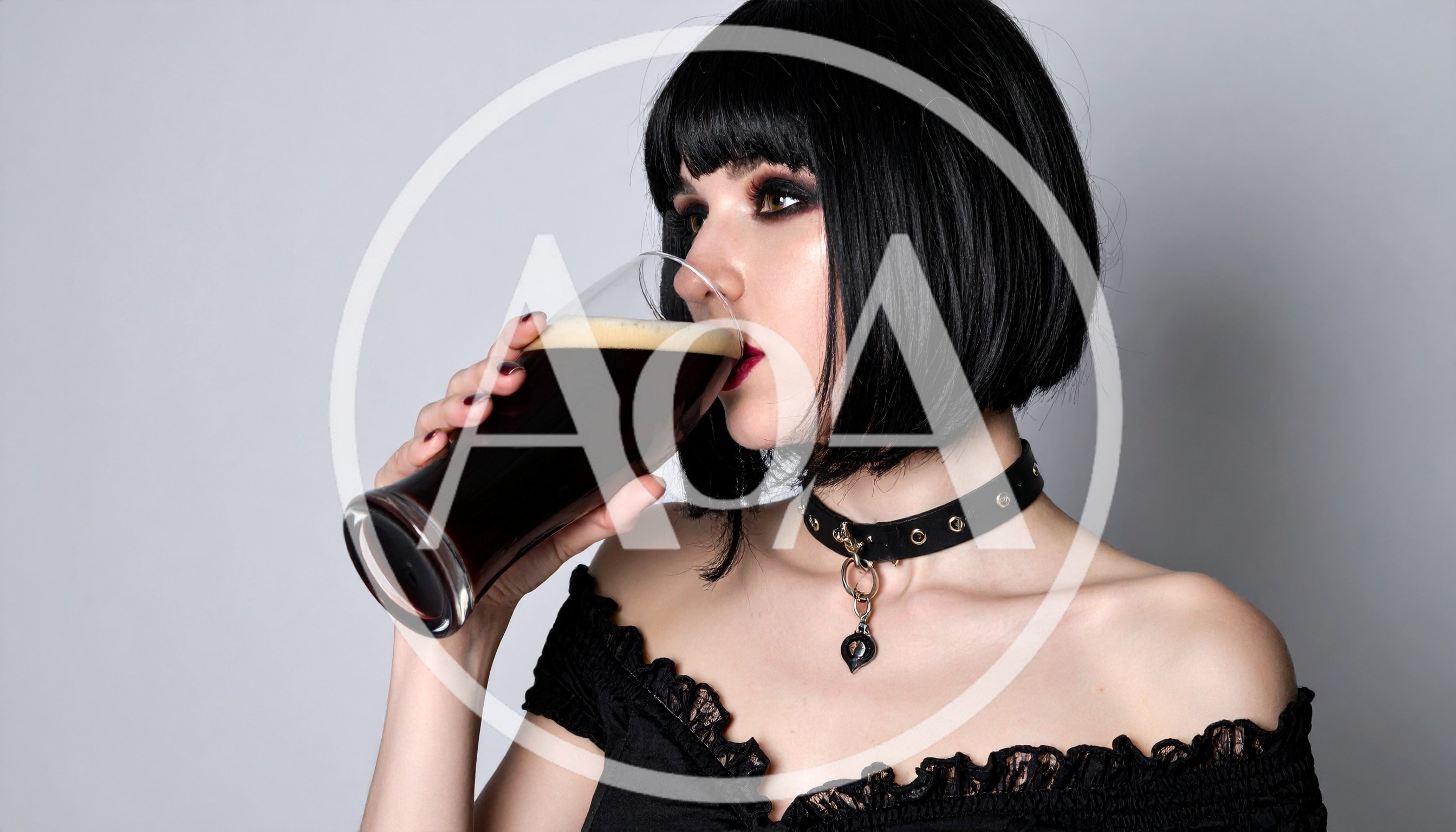 Goth Woman Drinking Dark Beer From A Glass