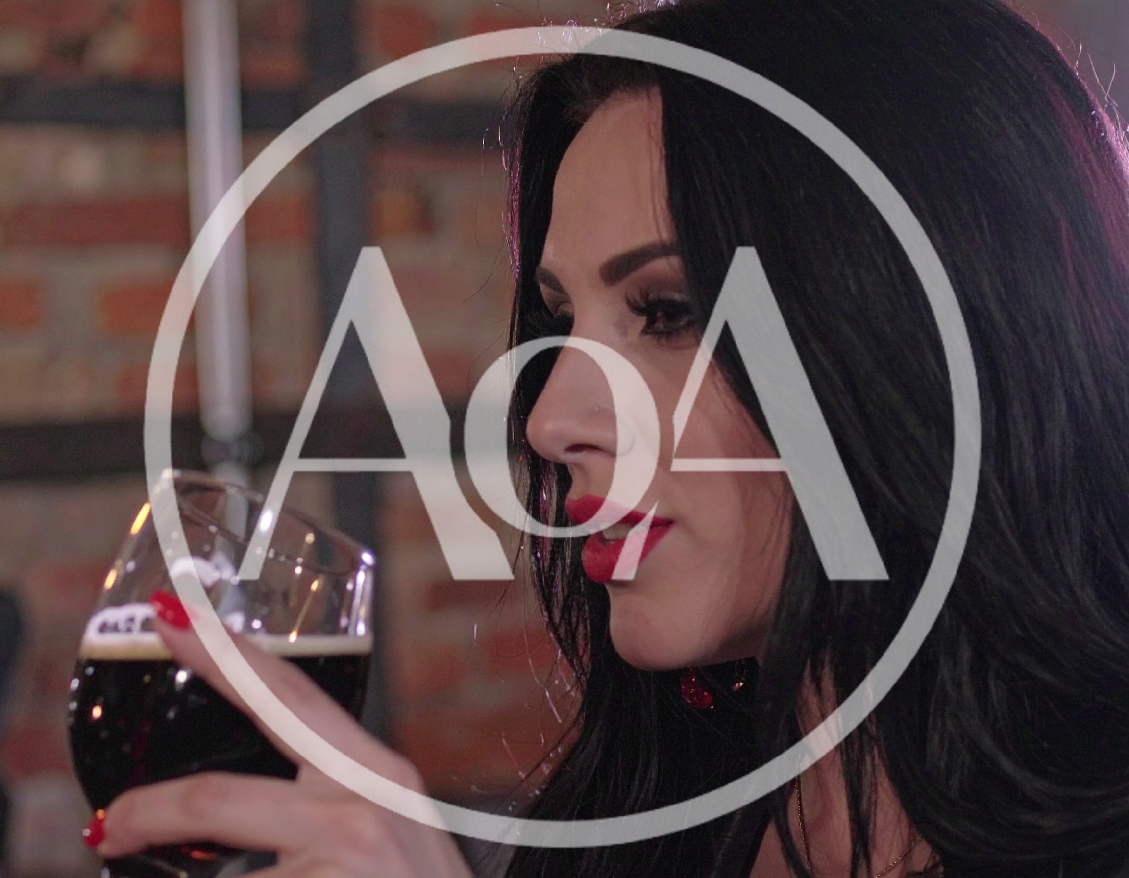 Beautiful Woman Drinking Dark Beer In A Pub