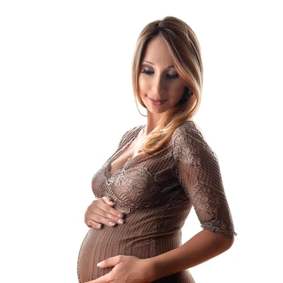Pregnant Woman Touching Her Belly In Studio