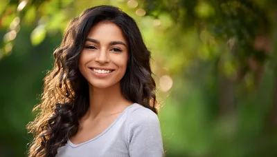 Portrait Of A Smiling Young Woman Outdoors