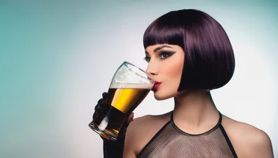 Stylish Woman Drinking Beer From A Glass