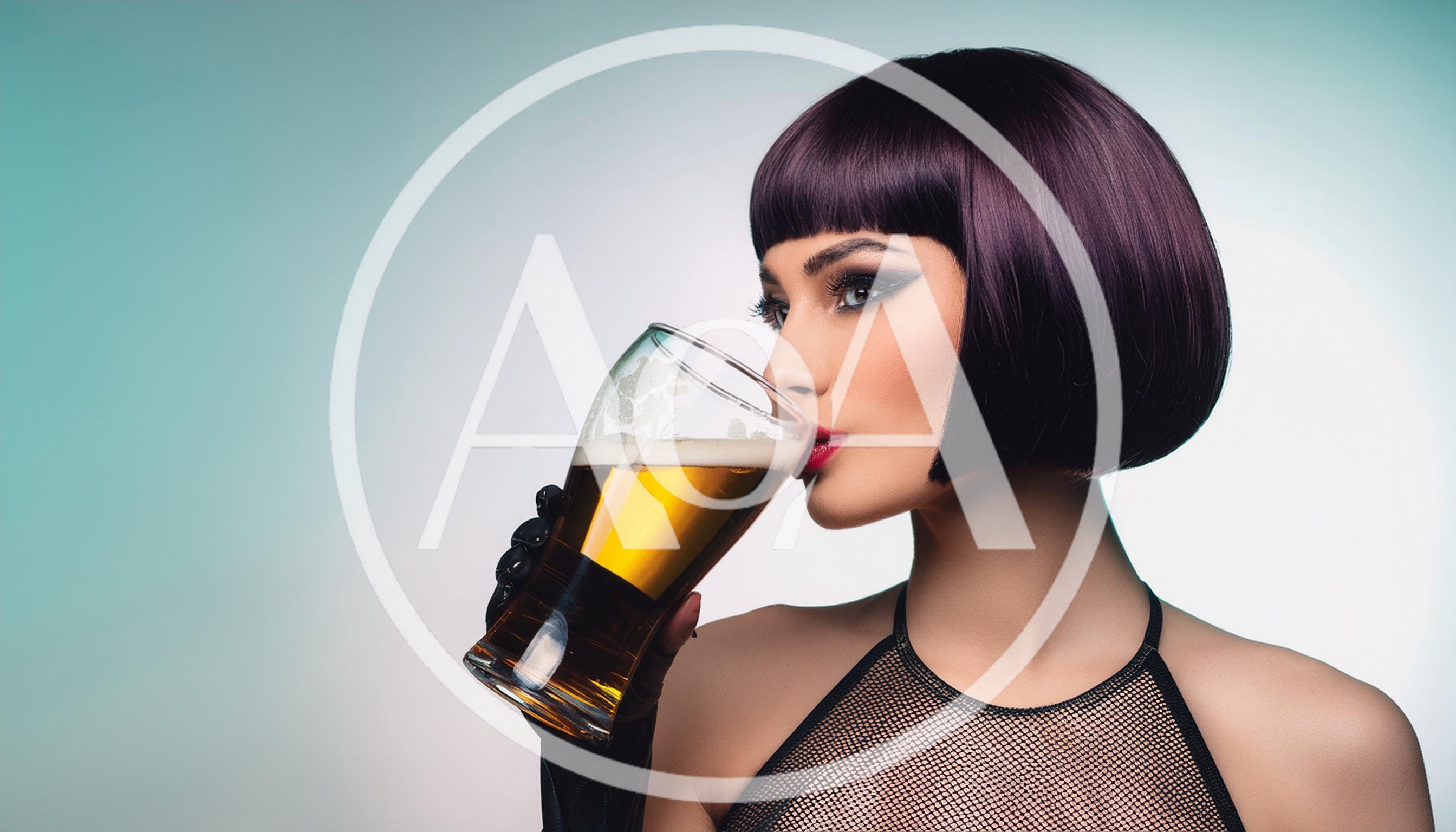 Stylish Woman Drinking Beer From A Glass