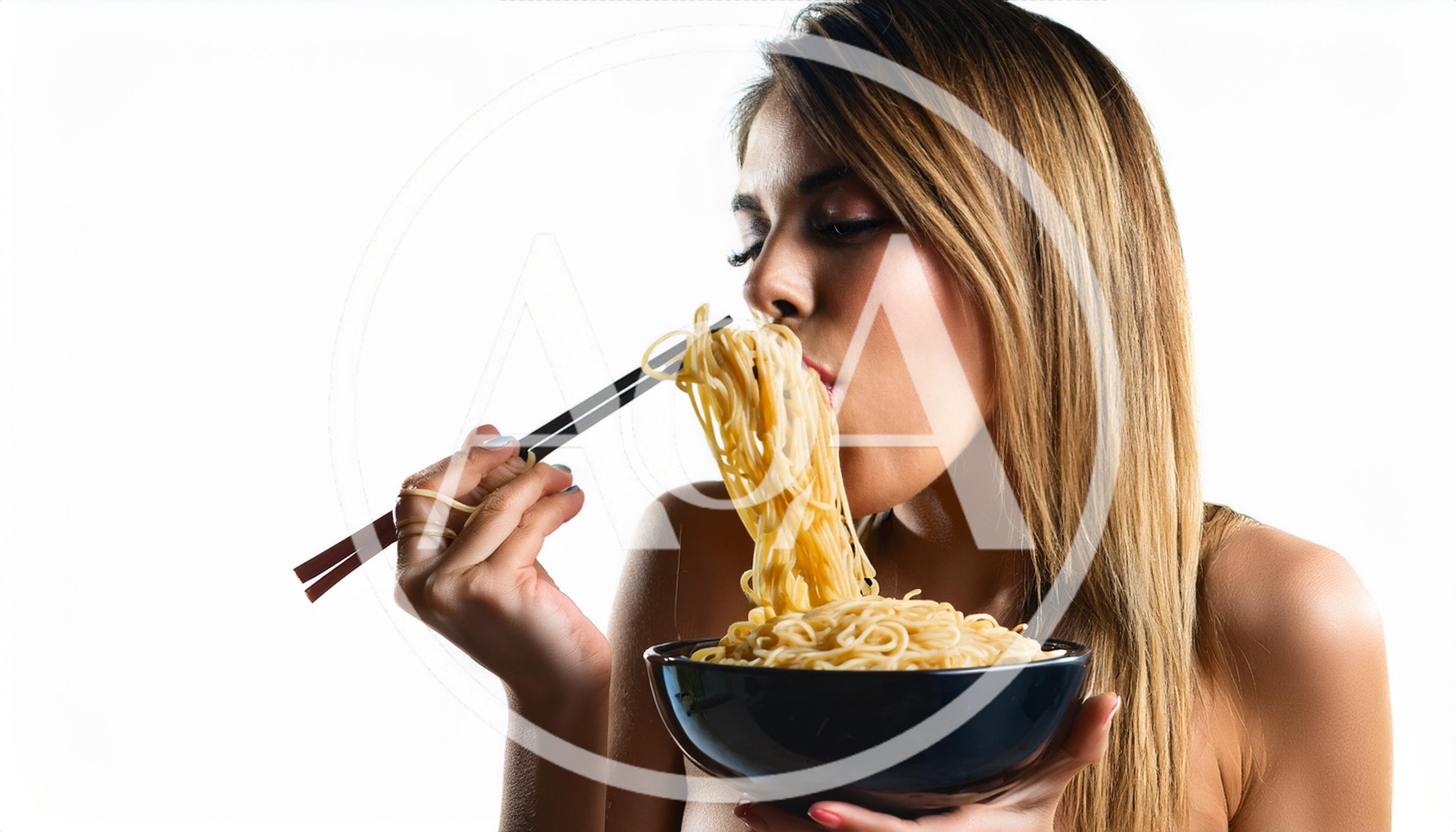 Young Woman Eating Noodles With Chopsticks