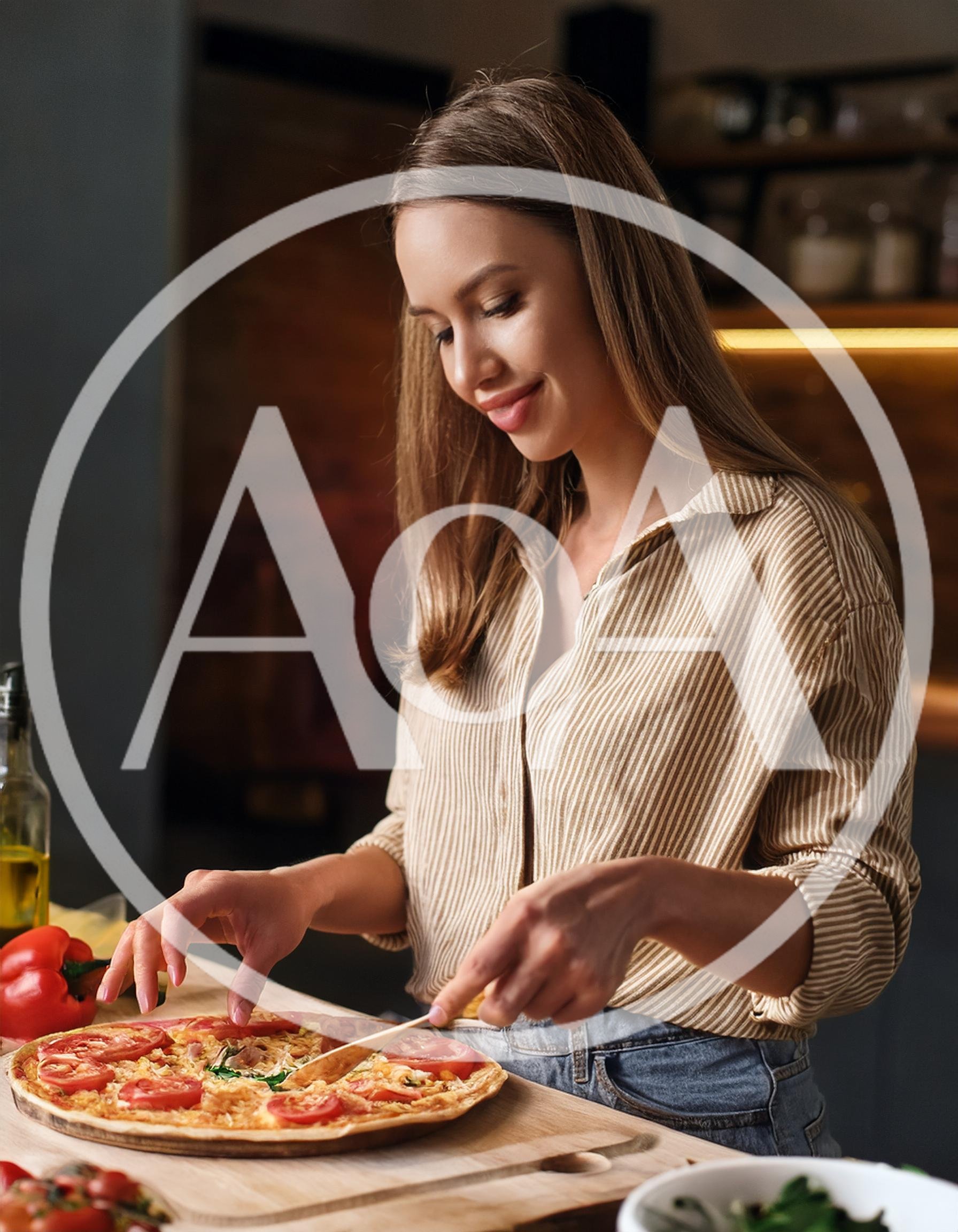 Young Woman Preparing Homemade Pizza In Kitchen
