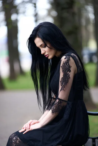 Pensive Woman With Long Black Hair In Lace Dress
