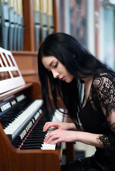 Young Woman Playing A Vintage Pipe Organ